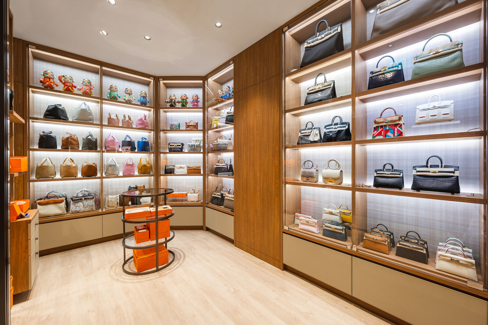 Glass-fronted vitrines, every shelf individually lit and dust-sealed. — Luxe Maison, Centre Point