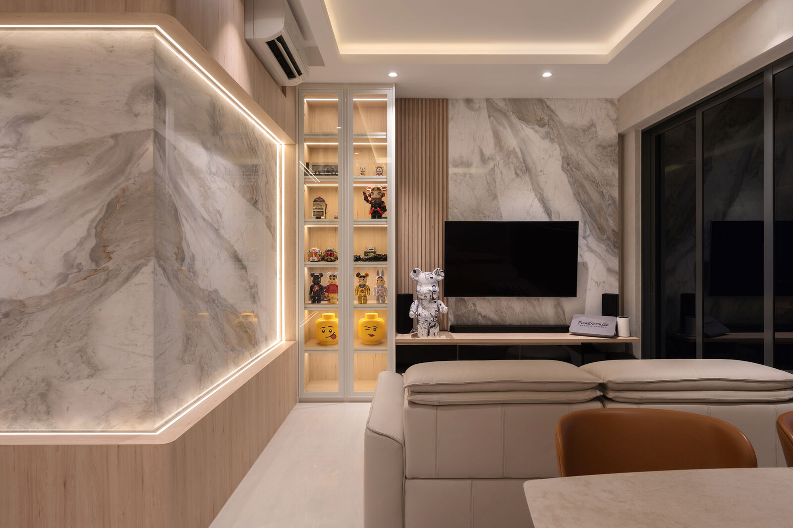 A full-height stone feature wall, cove-lit, with a display niche cut into the run. — Piermont Grand, Sumang Walk